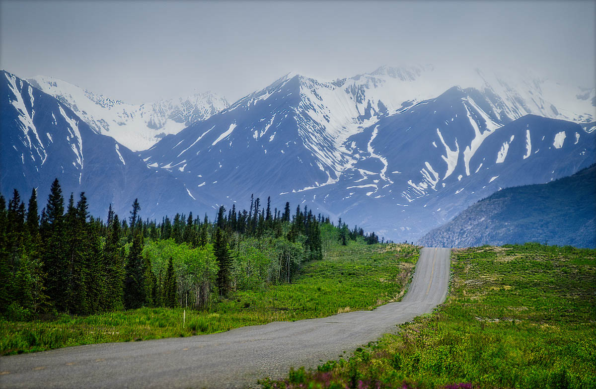 Alaska Highway between WHitehorse and Haines Junction, Yukon, The Kluane Range looms in the distance.